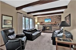 1317 Waterford Rd, Woodbury, MN 55125 - carpeted living room featuring beam ceiling and a fireplace