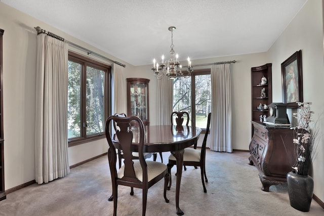 1317 Waterford Rd, Woodbury, MN 55125 - dining area with a chandelier, light carpet, healthy amount of natural light, and baseboards