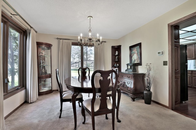 1317 Waterford Rd, Woodbury, MN 55125 - dining area featuring a chandelier, light carpet, baseboards, and a textured ceiling