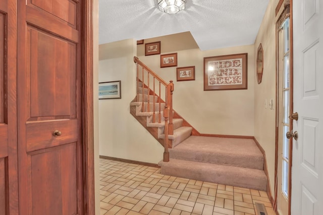 1317 Waterford Rd, Woodbury, MN 55125 - foyer entrance featuring stairway, a textured ceiling, baseboards, and brick patterned floors
