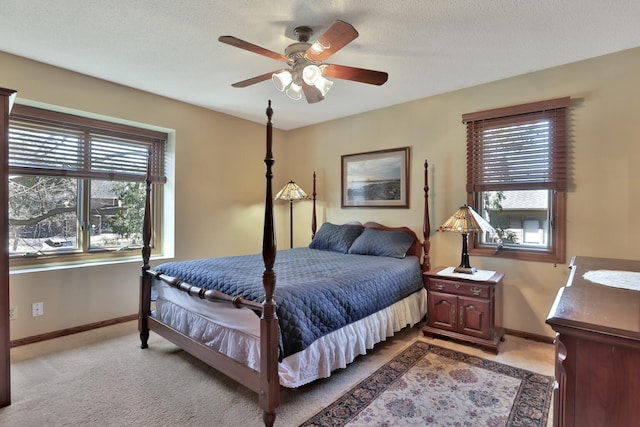 1317 Waterford Rd, Woodbury, MN 55125 - bedroom with light carpet, multiple windows, baseboards, and ceiling fan