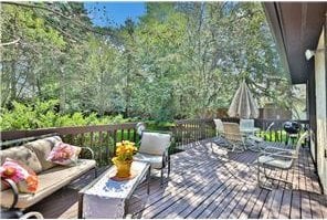 1317 Waterford Rd, Woodbury, MN 55125 - wooden terrace with outdoor lounge area, a forest view, and outdoor dining space