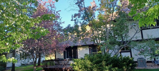 1317 Waterford Rd, Woodbury, MN 55125 - rear view of house featuring a wooden deck and cooling unit