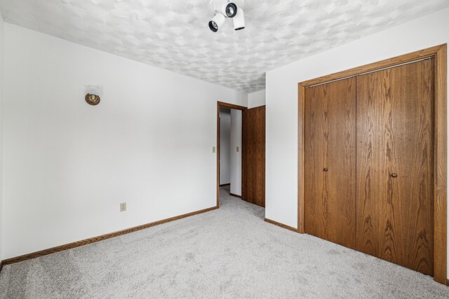 93 County 49 NW, Pine River, MN 56474 - unfurnished bedroom with carpet flooring, a closet, baseboards, and a textured ceiling