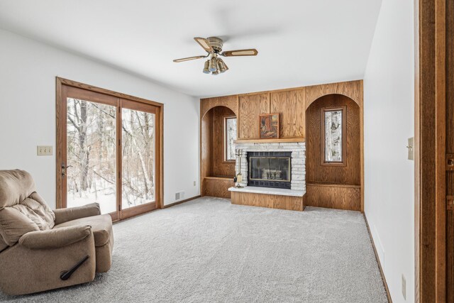 93 County 49 NW, Pine River, MN 56474 - living area with a ceiling fan, light colored carpet, a fireplace, baseboards, and arched walkways