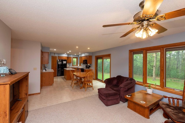 19988 Quentin Ave, Ravenna Twp, MN 55033 - living room featuring light colored carpet, ceiling fan, and recessed lighting