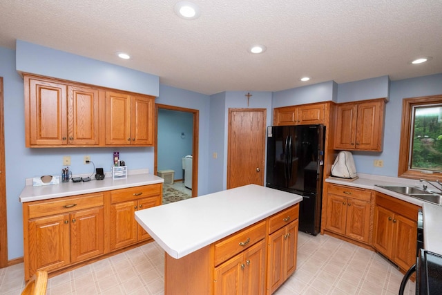 19988 Quentin Ave, Ravenna Twp, MN 55033 - kitchen with freestanding refrigerator, a sink, light countertops, light flooring, and a textured ceiling