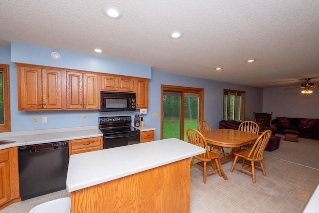 19988 Quentin Ave, Ravenna Twp, MN 55033 - kitchen featuring black appliances, light countertops, recessed lighting, a textured ceiling, and a kitchen island