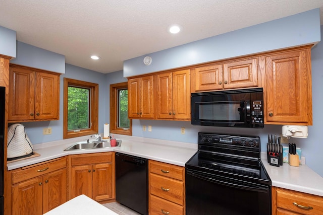 19988 Quentin Ave, Ravenna Twp, MN 55033 - kitchen featuring black appliances, a sink, light countertops, brown cabinetry, and recessed lighting