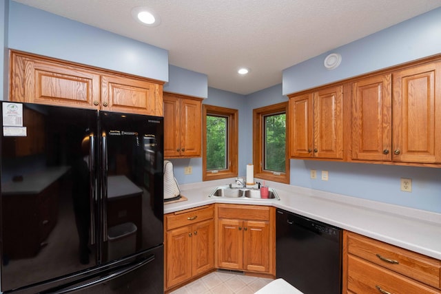 19988 Quentin Ave, Ravenna Twp, MN 55033 - kitchen with black appliances, a sink, brown cabinetry, and light countertops