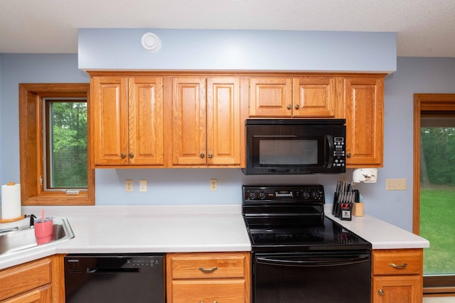 19988 Quentin Ave, Ravenna Twp, MN 55033 - kitchen with black appliances, light countertops, and a sink