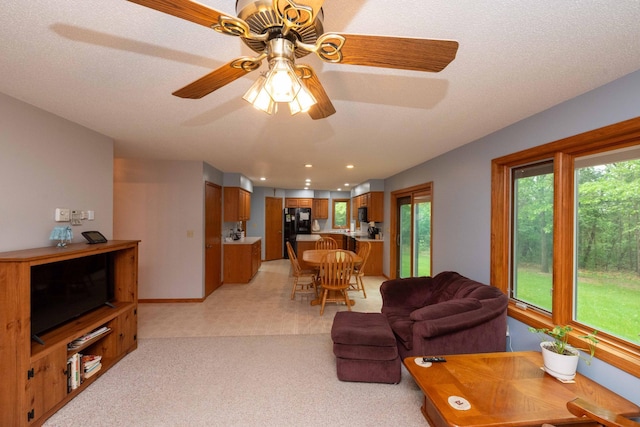 19988 Quentin Ave, Ravenna Twp, MN 55033 - living area featuring light carpet, plenty of natural light, a ceiling fan, and baseboards
