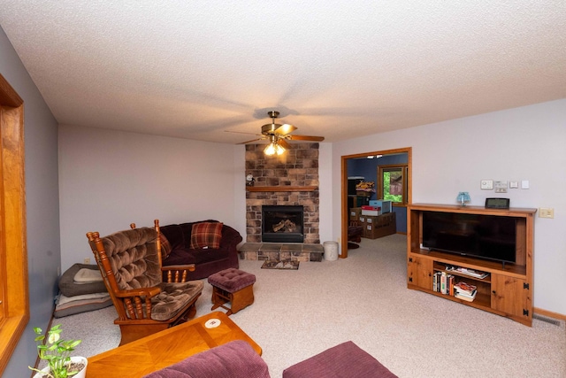 19988 Quentin Ave, Ravenna Twp, MN 55033 - carpeted living area featuring ceiling fan, a stone fireplace, and a textured ceiling