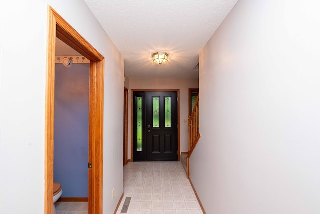 19988 Quentin Ave, Ravenna Twp, MN 55033 - doorway featuring baseboards and a textured ceiling