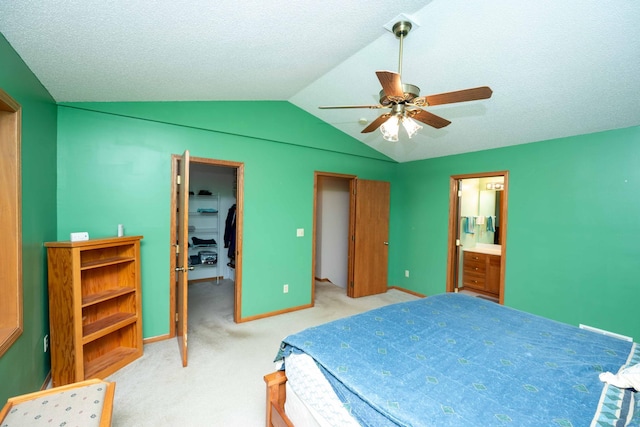 19988 Quentin Ave, Ravenna Twp, MN 55033 - bedroom featuring vaulted ceiling, a spacious closet, light carpet, connected bathroom, and ceiling fan