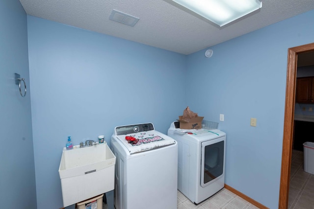 19988 Quentin Ave, Ravenna Twp, MN 55033 - washroom with washer and dryer, a textured ceiling, and baseboards