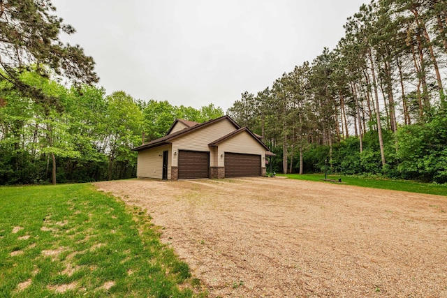 19988 Quentin Ave, Ravenna Twp, MN 55033 - garage featuring driveway and view of scattered trees