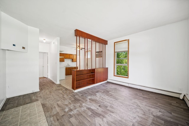 unfurnished living room featuring a baseboard radiator, light wood finished floors, and baseboards