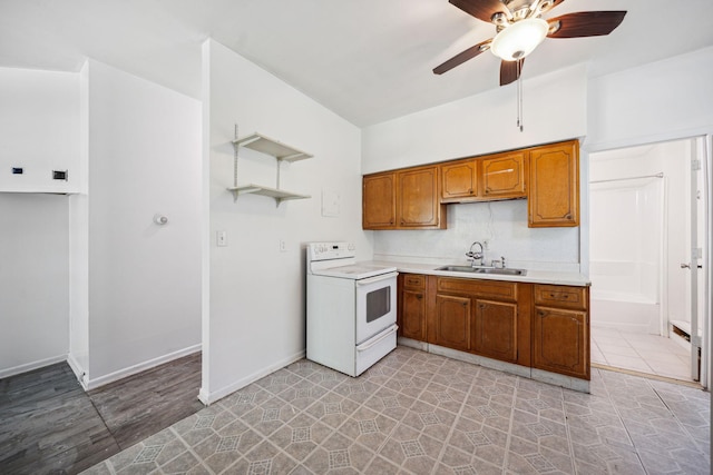 kitchen with a ceiling fan, electric stove, a sink, brown cabinets, and light countertops