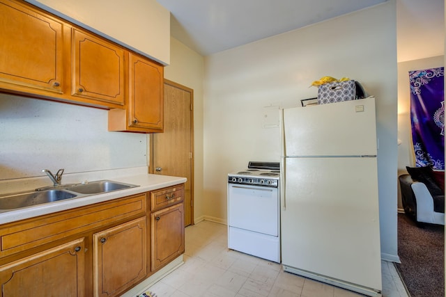 kitchen featuring brown cabinetry, a sink, white appliances, and light countertops