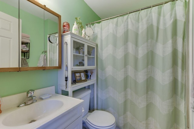 bathroom with vanity, a shower with shower curtain, and toilet