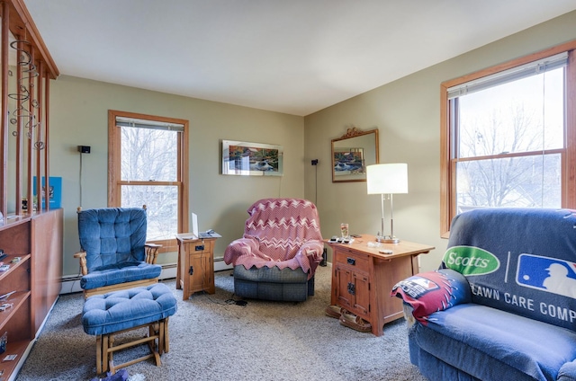 sitting room with a baseboard heating unit and light colored carpet