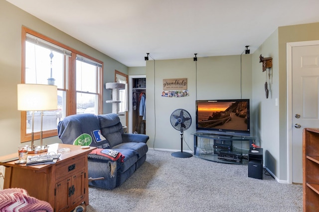 carpeted living room featuring baseboards