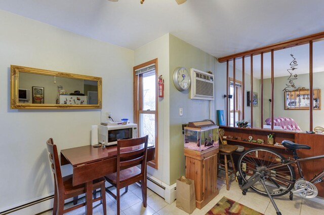 dining area with a baseboard heating unit, tile patterned flooring, and a wall mounted air conditioner