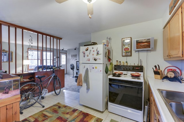 kitchen featuring light countertops, a ceiling fan, light tile patterned floors, a sink, and white appliances