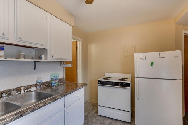 kitchen featuring white cabinets, a sink, light wood-style floors, white appliances, and open shelves