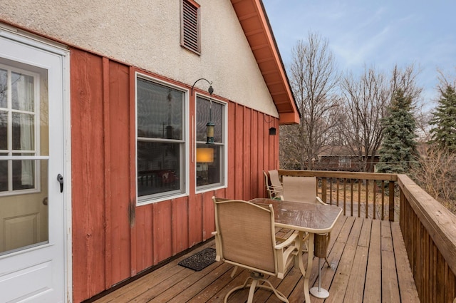wooden terrace featuring outdoor dining area