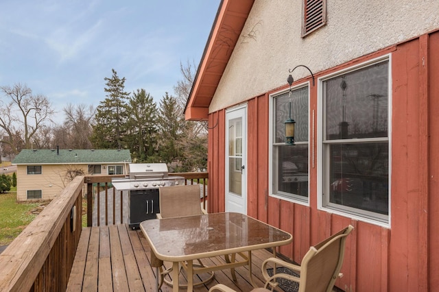 wooden deck featuring outdoor dining area and area for grilling