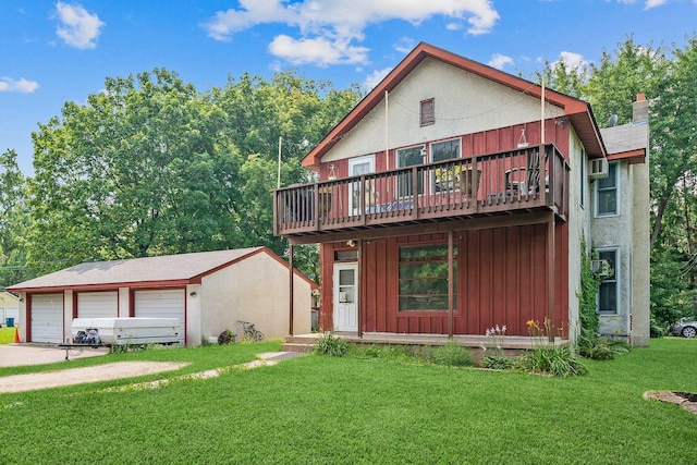 chalet / cabin featuring an outbuilding, a front lawn, a detached garage, a wooden deck, and board and batten siding