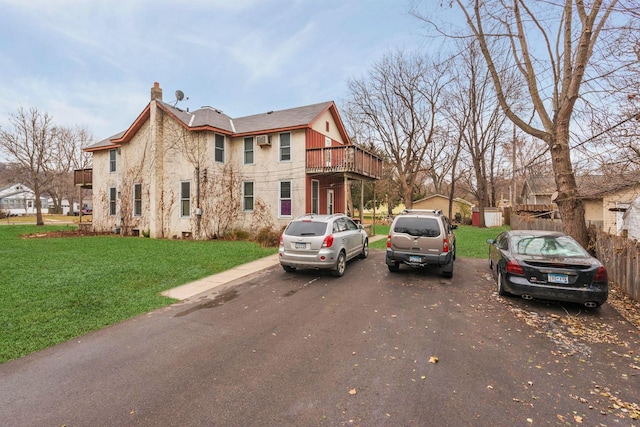 view of home's exterior with a chimney and a yard