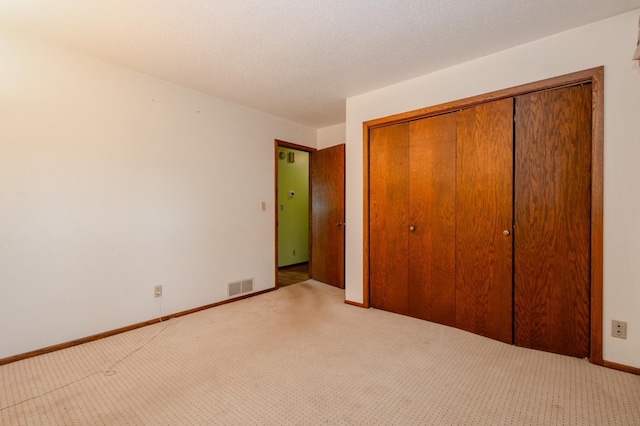 1002 11th Ave W, Alexandria, MN 56308 - unfurnished bedroom featuring carpet floors and a closet