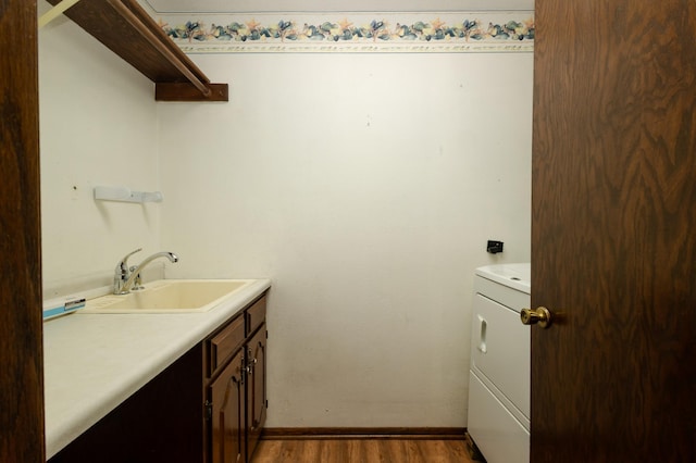1002 11th Ave W, Alexandria, MN 56308 - laundry room with cabinet space, washer / clothes dryer, and dark wood finished floors