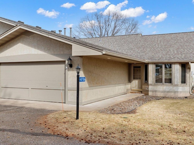 exterior space with roof with shingles and stucco siding