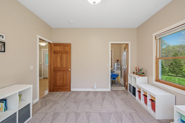 interior space with carpet and baseboards
