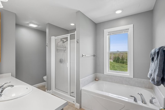 bathroom featuring toilet, vanity, tile patterned flooring, a shower stall, and a bath