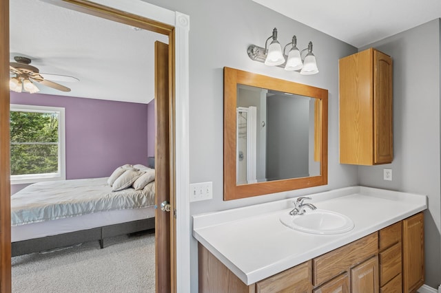 ensuite bathroom with vanity, ensuite bath, and a ceiling fan