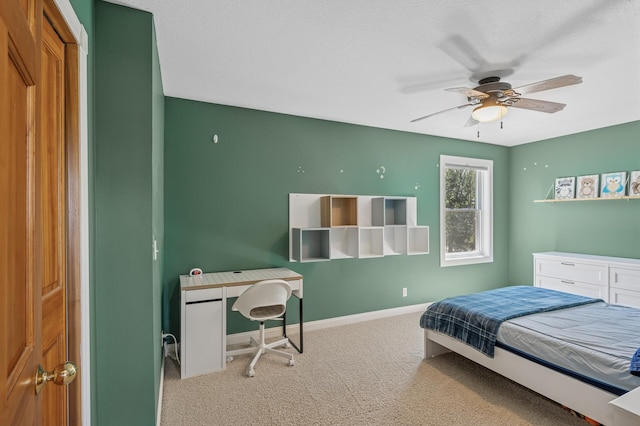 carpeted bedroom featuring baseboards and a ceiling fan