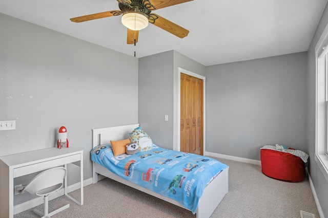 bedroom featuring baseboards, carpet flooring, visible vents, and a ceiling fan