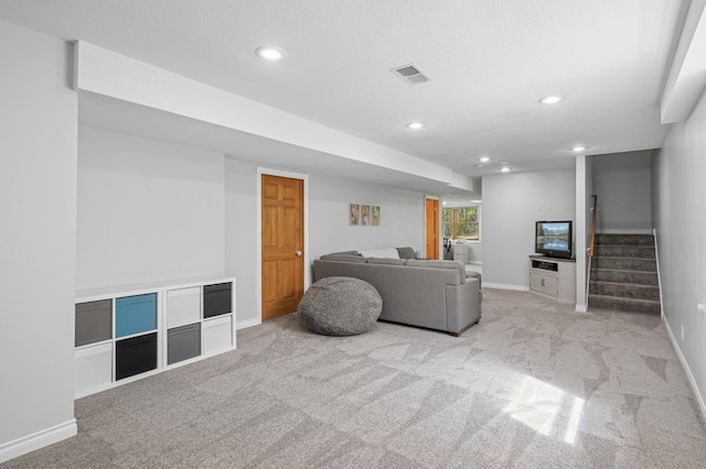 carpeted living area with baseboards, stairs, visible vents, and recessed lighting