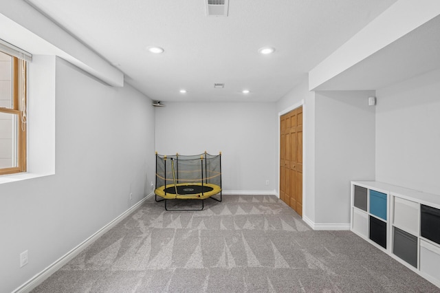 living area with carpet flooring, visible vents, baseboards, and recessed lighting