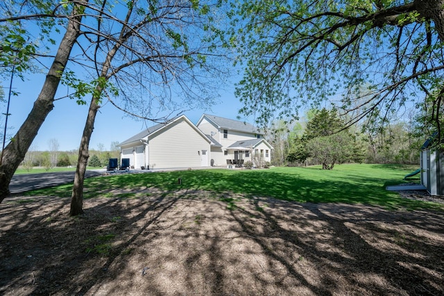 exterior space featuring a yard, driveway, and an attached garage