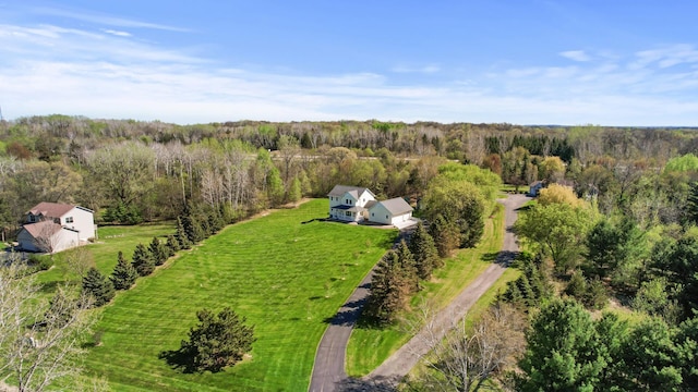 birds eye view of property with a wooded view