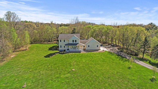 drone / aerial view featuring a forest view