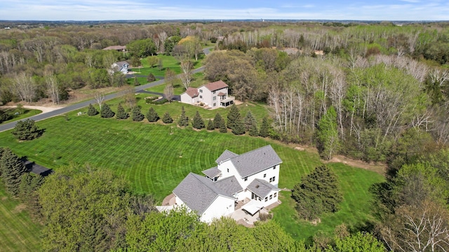 drone / aerial view featuring a view of trees