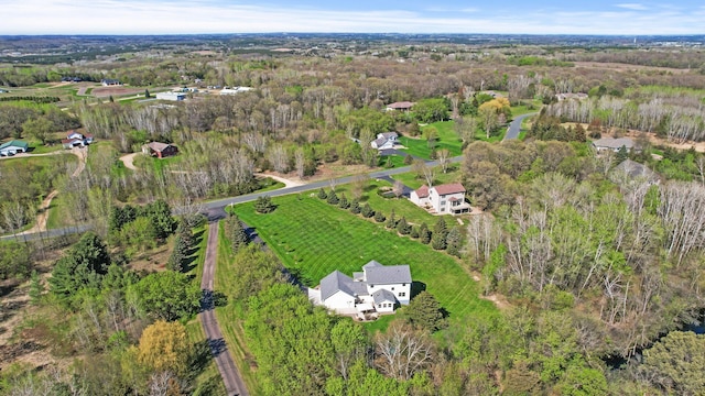 birds eye view of property featuring a rural view and a view of trees