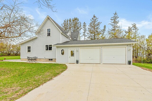 traditional-style home with concrete driveway, a garage, and a front lawn